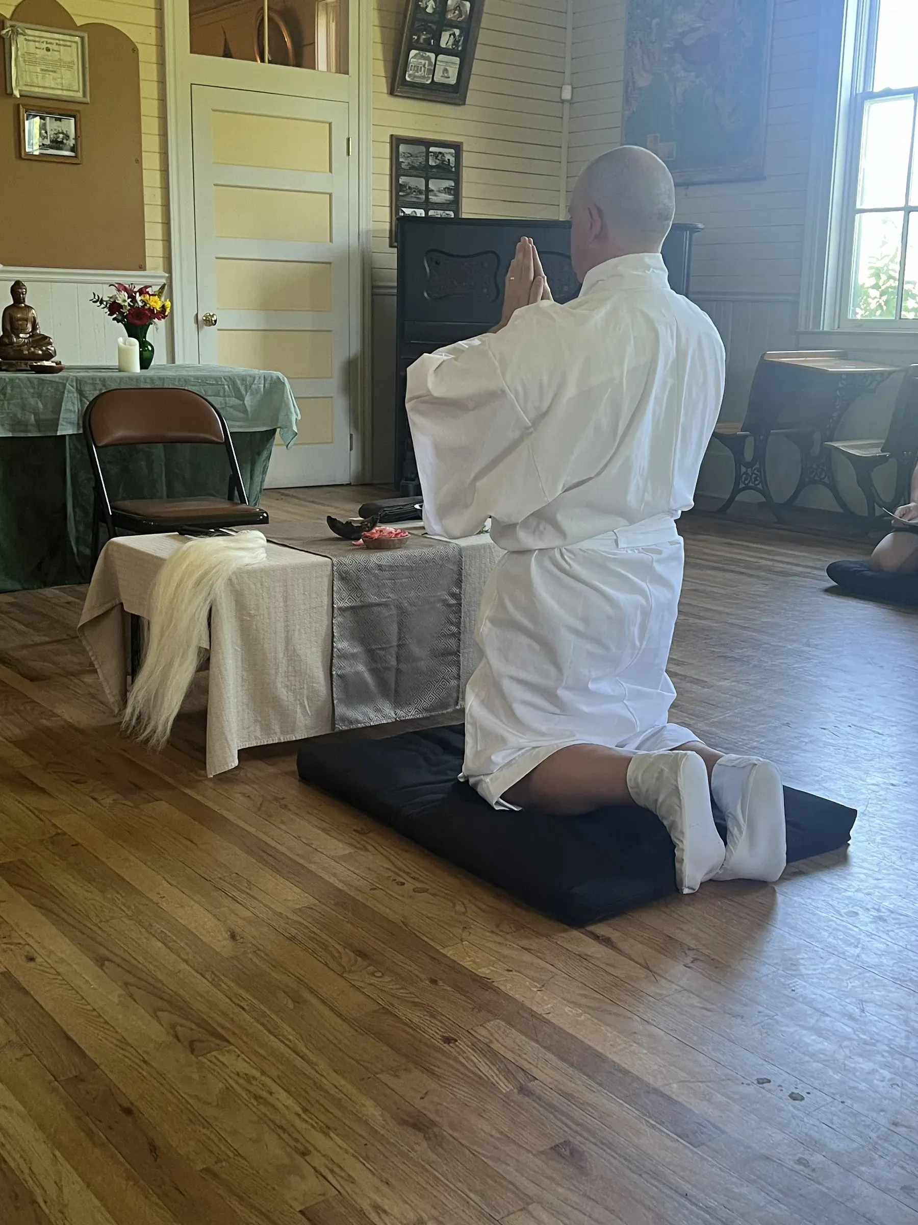 Sōbu Tetsuzan Jeff Urmston taking precepts from Rev. Shinzan Sekibu Alice Tulloch during his shukke tokudo ceremony.