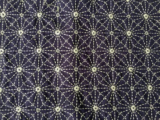 A piece of sashiko embroidery with intricate patterns.