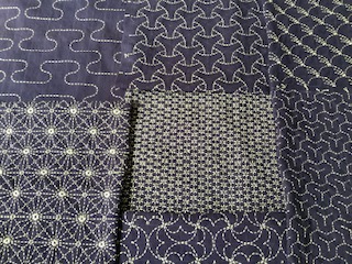 A piece of sashiko embroidery with intricate patterns.