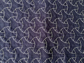 A piece of sashiko embroidery with intricate patterns.